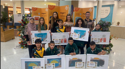 Students receiving awards and framed images at the Drawing us together competition.