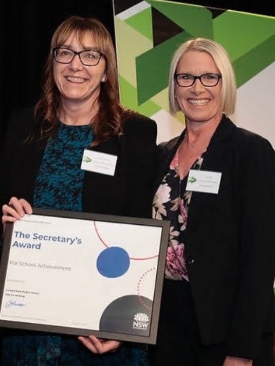 The principal and DP receiving an award.