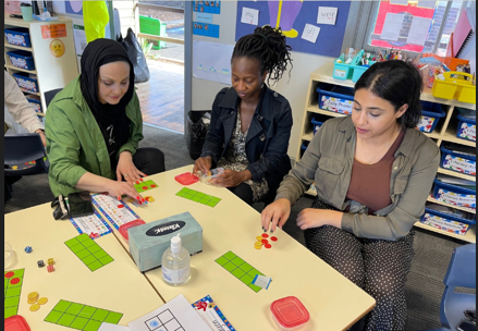 Three parents participating in a maths session to support their knowledge of what we do.