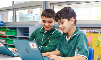 Two students sitting at laptops.
