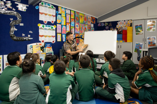 Teacher reading a book to students in the library.